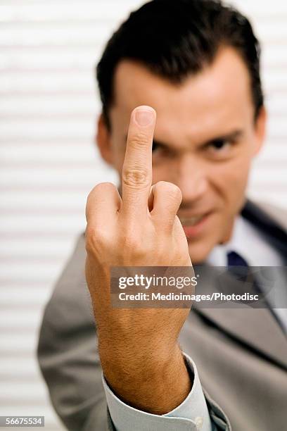 portrait of a businessman showing obscene gesture - ugly bald man stock pictures, royalty-free photos & images