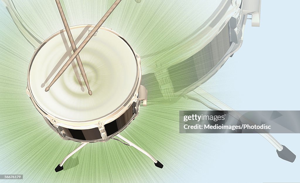 High angle view of a drum with drumsticks