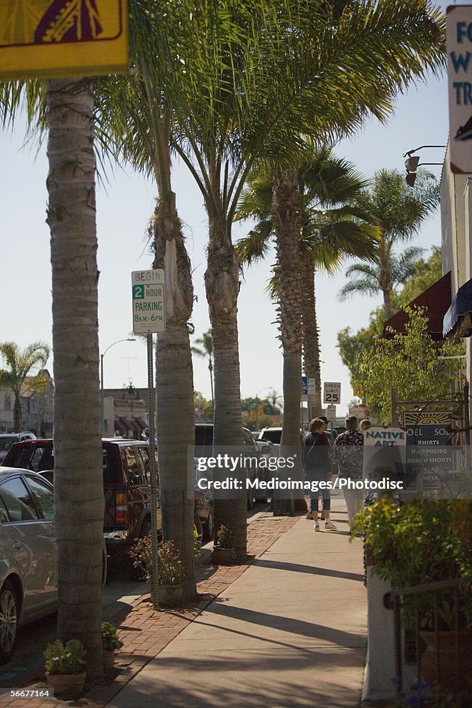 Rear view of people walking on a city street, Old Town San Diego, California, USA