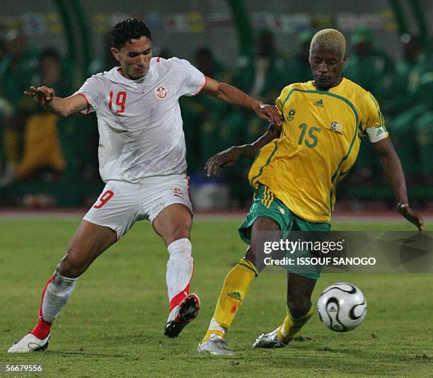 Tunisian player Anis Ayari vies with South African player Sibusiso Zuma during their Group C African Nations Cup football match at the Haras...