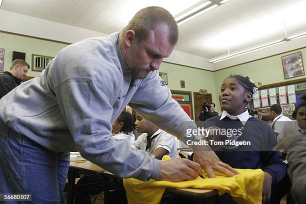 Detroit Lion players Cory Schlesinger and Jeff Backus visit a fifth grade classroom at the Malcolm X Academy on January 26, 2006 in Detroit,...