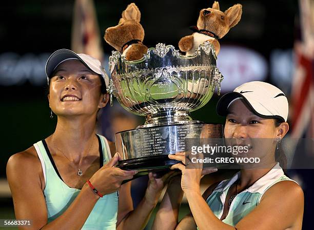China's Zi Yan and Jie Zheng pose with their trophy after winning the Australian Open tennis tournament women's doubles final match against Lisa...