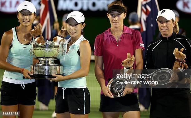 China's Zi Yan and Jie Zheng pose with their trophy after defeating Lisa Raymond of the US and Australia's Samantha Stosur in the Australian Open...