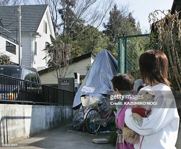 Pedestrian walk past a house , which house 10 women and a baby living together with Japanese 57-year-old man, in Higashi-Yamato, western Tokyo, 27...