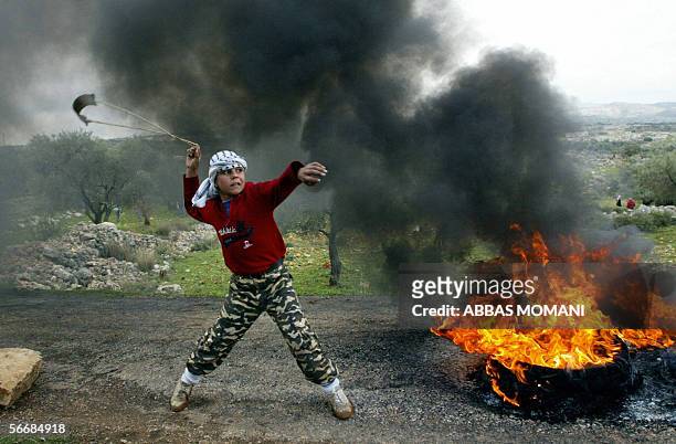 Palestinian child throws stones at Israeli soldiers during a demonstrations agaisnt the Israeli separation barrier in the West Bank city of Ramallah,...