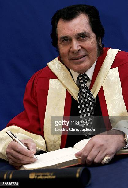 Legendary singer Engelbert Humperdinck signs the official documents for the acceptance of his honorary Doctor Of Music degree from the University Of...