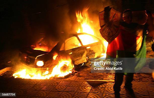 Car burns during a demonstration by Fatah members outside the Palestinian parliament January 27, 2006 in Gaza City, Gaza Strip. Thousands of Fatah...