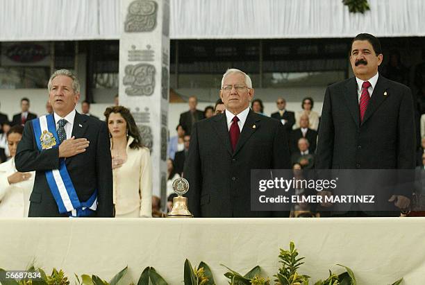 Tegucigalpa, HONDURAS: Honduran outgoing President Ricardo Maduro sings the national anthem next to successor Manuel Zelaya Rosales and the president...