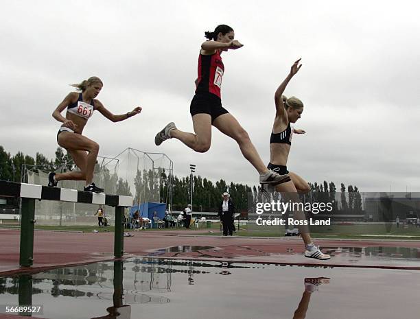 Kate McIlroy lands on her way to a win in the Senior Womens 3000m steeplechase ahead of second placed Fiona Crombie and 3rd placed Rebecca Furlong at...