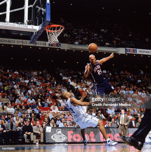 Richard Jefferson of the New Jersey Nets loses control of the ball as Grant Hill of the Orlando Magic takes the charge at TD Waterhouse Centre on...
