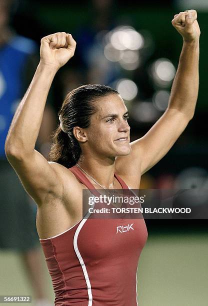 France's Amelie Mauresmo celebrates after she won an Australian Open tennis tournament final match against Belgium's Justine Henin-Hardenne in...