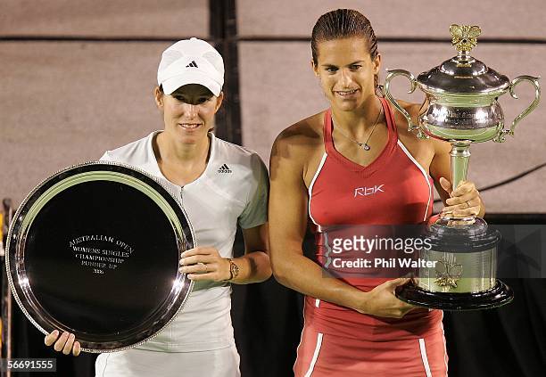 Justine Henin-Hardenne of Belguim and Amelie Mauresmo of France pose for photographers after their Women's Singles Final match during day thirteen of...