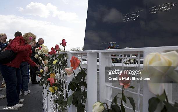 Visitors to the Kennedy Space Center Visitor's Complex place flowers around the Space Mirror Memorial after a memorial service on the 20th...