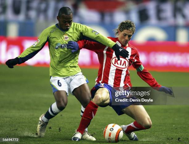 Fernando Torres of Atletico Madrid is tackled by Julian de Guzman of Deportivo La Coruna during a Primera Liga match between Atletico Madrid and...