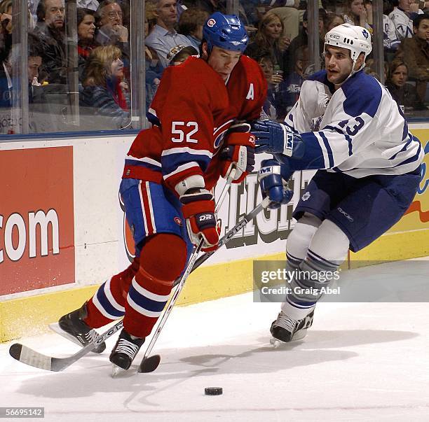 Craig Rivet of the Montreal Canadiens battles for the puck with Jay Harrison of the Toronto Maple Leafs at Air Canada Centre January 28, 2006 in...