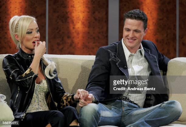 Formula one driver Ralf Schumacher and his wife Cora Schumacher gesture during the live broadcast of German TV show "Wetten, dass..?" at the Salzburg...
