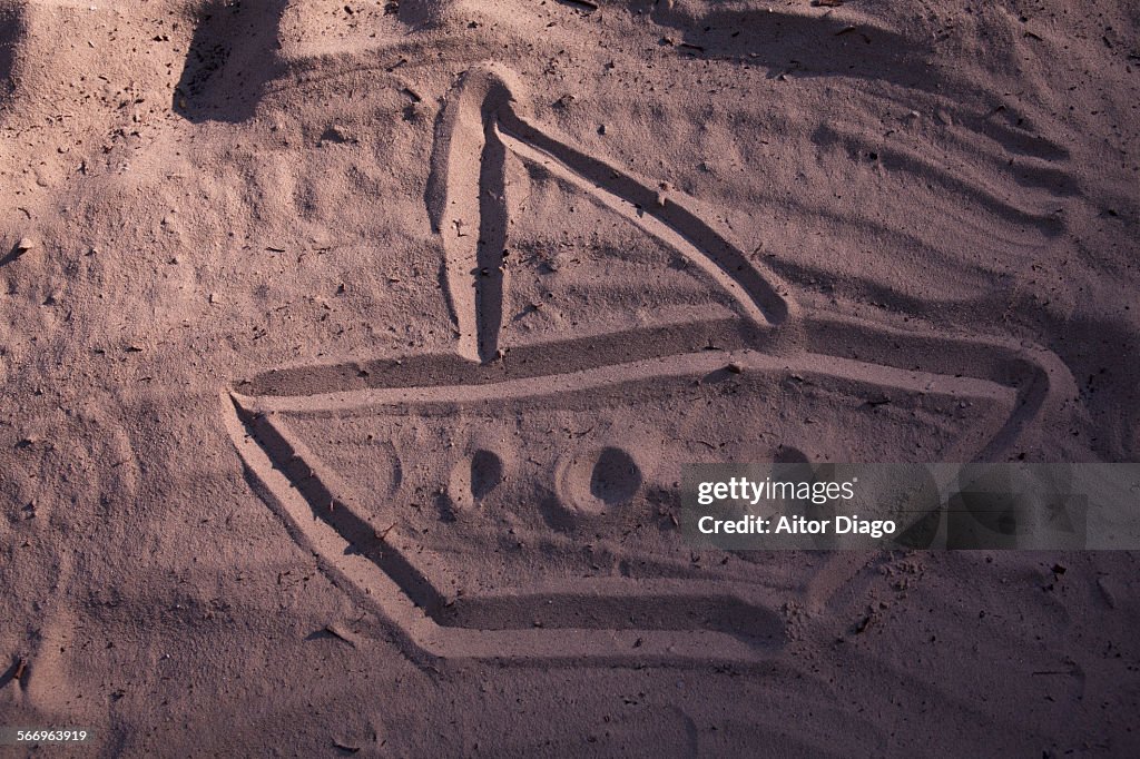 Drawing in sand of a boat.