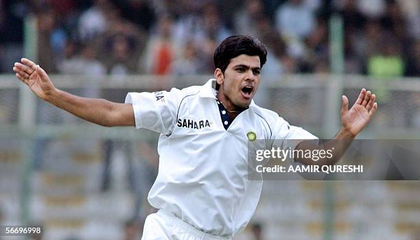 Indian cricketer Rudra Pratap Singh celebrates after he taking the wicket of Pakistani batsman Abdul Razzaq during the first day of the third and...