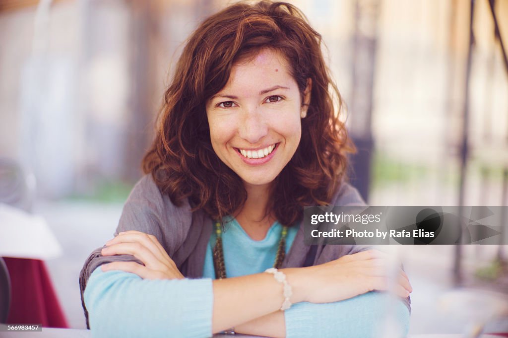 Pretty woman smiling with crossed arms