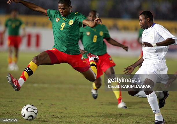 Cameroonian forward Samuel Eto'o jumps for the ball ahead of Congolese captain Lomana LuaLua , during the knock-out round game between the...