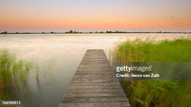jetty at moonrise - flevoland stock pictures, royalty-free photos & images