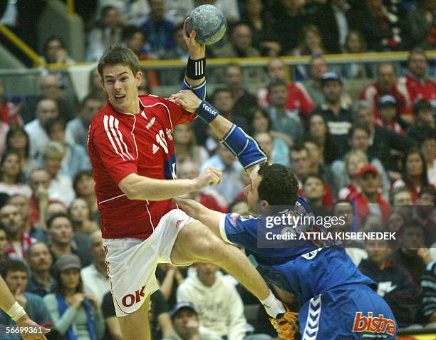 Dane Per Leegaard is fouled by Serbian Alem Toskic in a group C match in the European handball championships in Sursee 29 January 2006.
