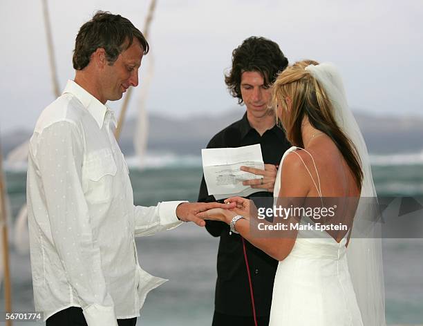 Lhotse Merriam places a wedding band on Tony Hawk's finger during their wedding ceremony January, 12 2006 on the Island of Tavarua in Fiji.