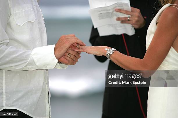 Tony Hawk places a wedding ring on his bride Lhotse Merriam's finger during their wedding ceremony January, 12 2006 on the Island of Tavarua in Fiji.