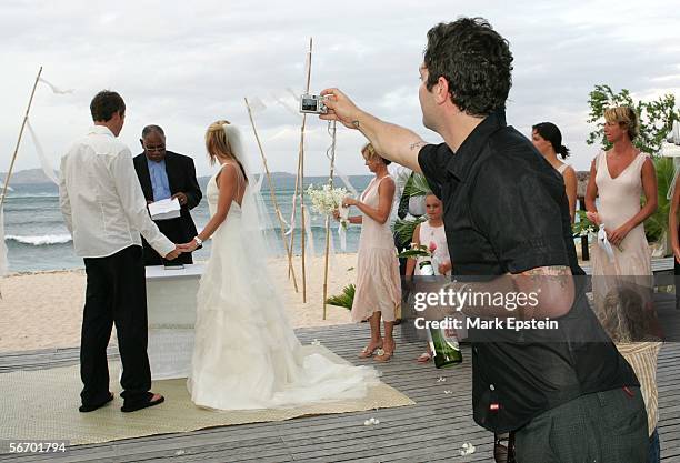 Skateboarder Tony Hawk and Lhotse Merriam are read their wedding vows while Bam Margera of "Viva La Bam" snaps a photo January, 12 2006 on the Island...