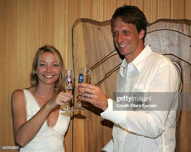 Newlyweds Tony Hawk and Lhotse Merriam toast as they celebrate their marriage January, 12 2006 on the Island of Tavarua in Fiji.