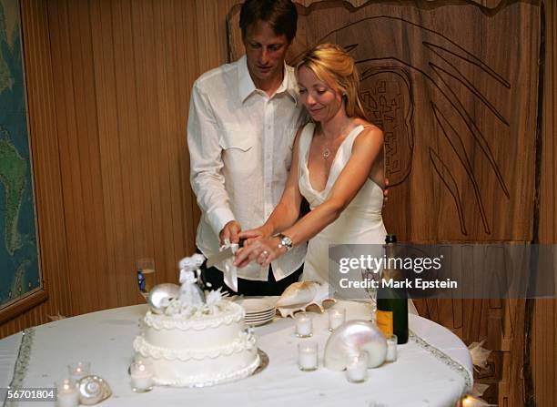 Newlyweds Tony Hawk and Lhotse Merriam cut a slice of cake at their wedding reception January, 12 2006 on the Island of Tavarua in Fiji.