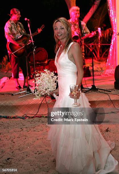 Lhotse Merriam looks on as Rancid perform in the background during her wedding reception January, 12 2006 on the Island of Tavarua in Fiji.