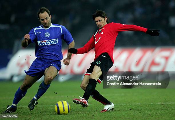 Thomas Brdaric of Hanover challenges for the ball with Dick van Burik of Berlin during the Bundesliga match between Hertha BSC Berlin and Hanover 96...