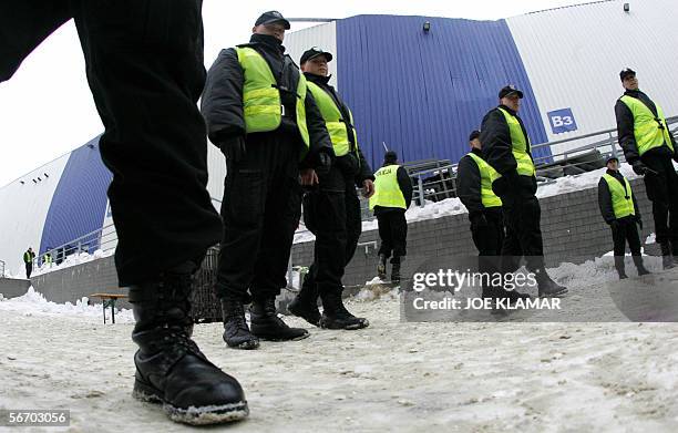 Polish policemen guard outside of the collapsed exhibition hall in the southern city of Chorzow, near Katowice, southern Poland, 30 January 2006....