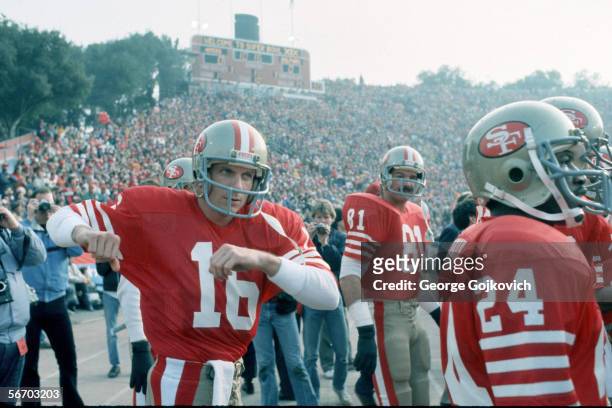 Quarterback Joe Montana of the San Francisco 49ers stretches while waiting to be introduced before the start of Super Bowl XIX against the Miami...