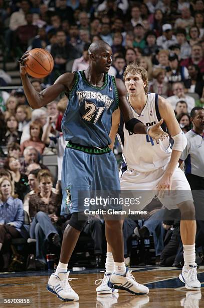 Kevin Garnett of the Minnesota Timberwolves looks to move the ball against Dirk Nowitzki of the Dallas Mavericks during the game at American Airlines...
