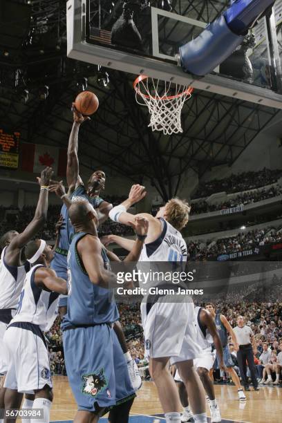 Kevin Garnett of the Minnesota Timberwolves lays up a shot from in the key over Dirk Nowitzki of the Dallas Mavericks during the game at American...