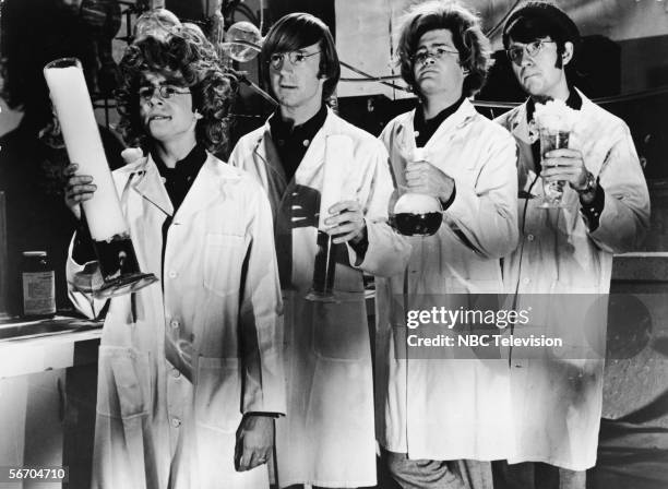 Television still shows the popular music and television group the Monkees dressed as 'mad scientists,' complete with bubbling beakers, lab coats, and...