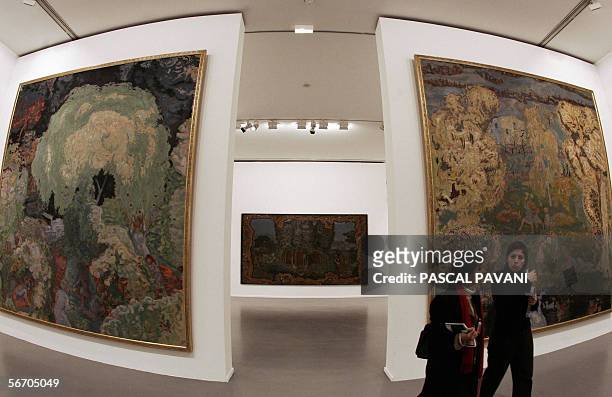 Visitors walk past artworks by French painter Pierre Bonnard "l'automne, les vendanges" -Fall, Wine Harvest , "apres le deluge" -After The Deluge and...