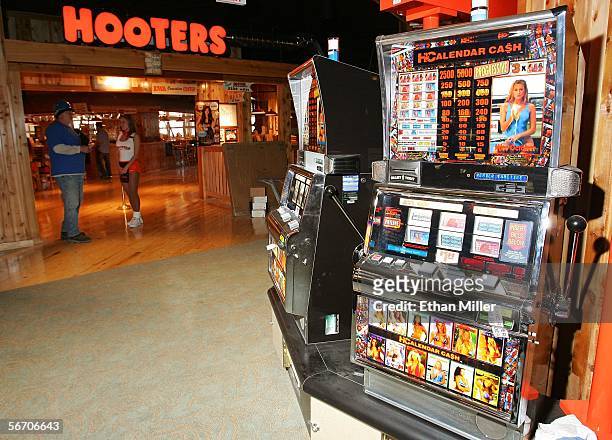 Hooters-themed slot machines are seen outside the entrance to the Hooters Restaurant inside the world's first Hooters Casino Hotel January 30, 2006...