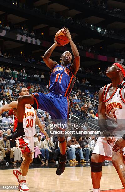 Jamal Crawford of the New York Knicks shoots as Salim Stoudamire and Al Harrington of the Atlanta Hawks look on during a game on January 30, 2006 at...