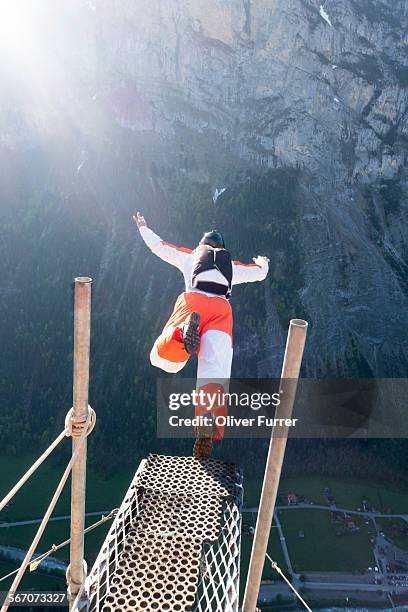 base jumper kicked off a ramp down into the valley - base jumping stock pictures, royalty-free photos & images