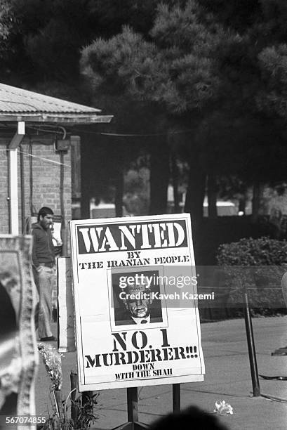 Banner with a photo of The Shah inside the American Embassy compound occupied by students following the Imam Khomeini's line calls him a No.1...