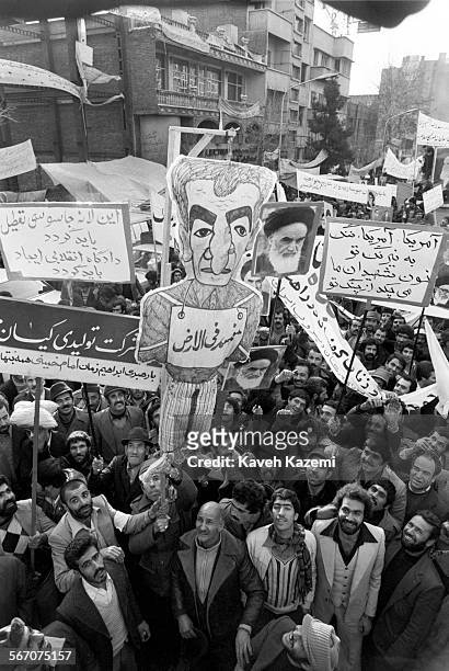 Demonstrators hold an effigy of the Shah of Iran and posters of Ayatollah Khomeini outside the American Embassy which is occupied by "students...