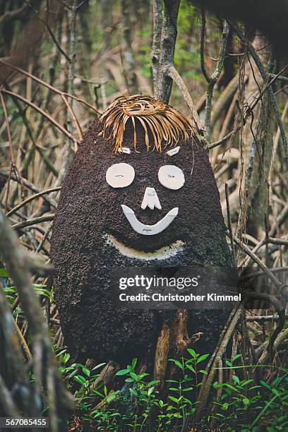 facial features are added to a termite hill to make it look life a human face. - isoptera stock pictures, royalty-free photos & images