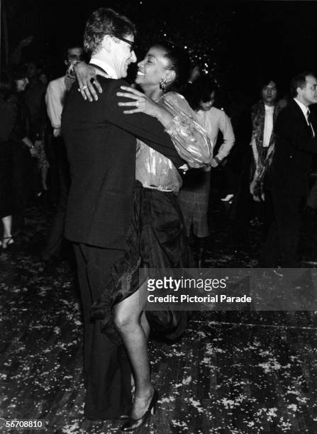 Algerian-born French fashion designer Yves St. Laurent with an unidentified guest at a fundraiser for UNICEF at Club 78, Paris, France, January 31,...