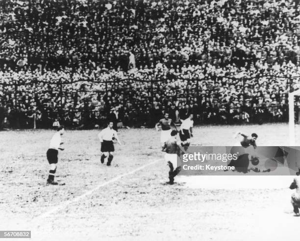 Giuseppe Meazza of Italy out-plays an Austrian forward to set up Enrico Guaita to score, ten minutes into his team's World Cup semifinal against...
