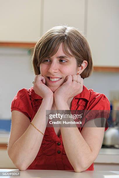 young blind woman relaxing in her kitchen - leaning on elbows stock pictures, royalty-free photos & images
