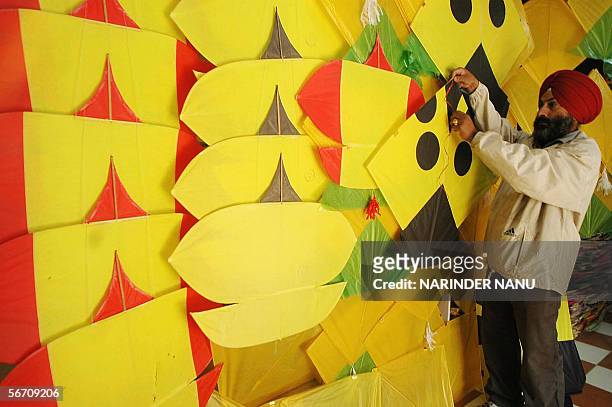 Indian kite maker, Gurinder Singh displays yellow kites at his Kite Shop In Amritsar, 31 January 2006. Kites are in heavy demand for the upcoming...