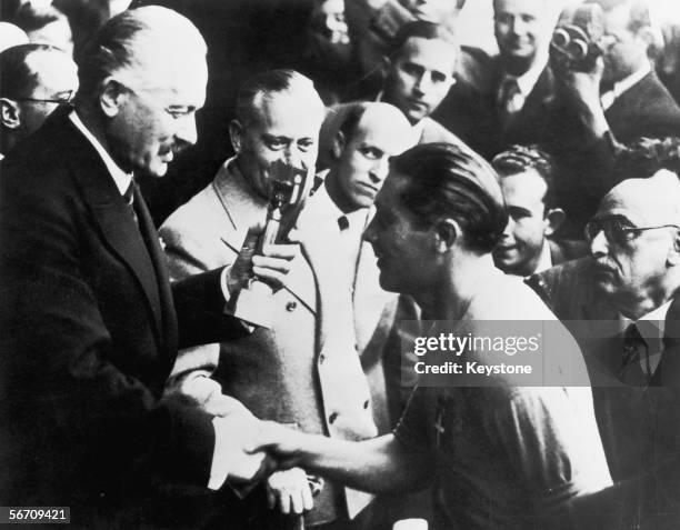 Italian captain Giuseppe Meazza receives the Jules Rimet trophy after his team's 4-2 victory over Hungary in the World Cup final at the Stade...